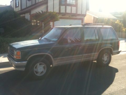 1993 Ford Taurus - This 1995 Ford Explorer is shown from the side, parked in front of a house.