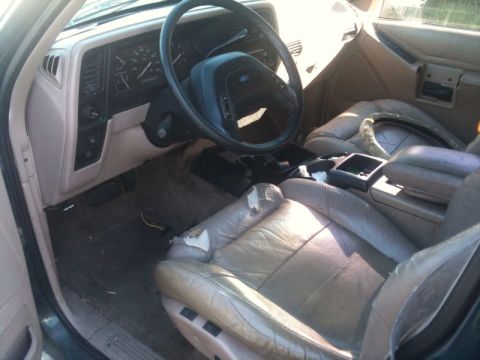 1993 Ford Taurus - The interior of a 1993 Ford Explorer features worn leather seats and a dashboard with visible gauges.
