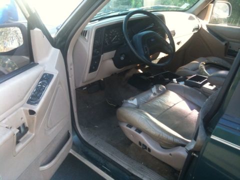 1993 Ford Taurus - Interior of a 1993 Ford Explorer, showing worn leather seats and dashboard details.
