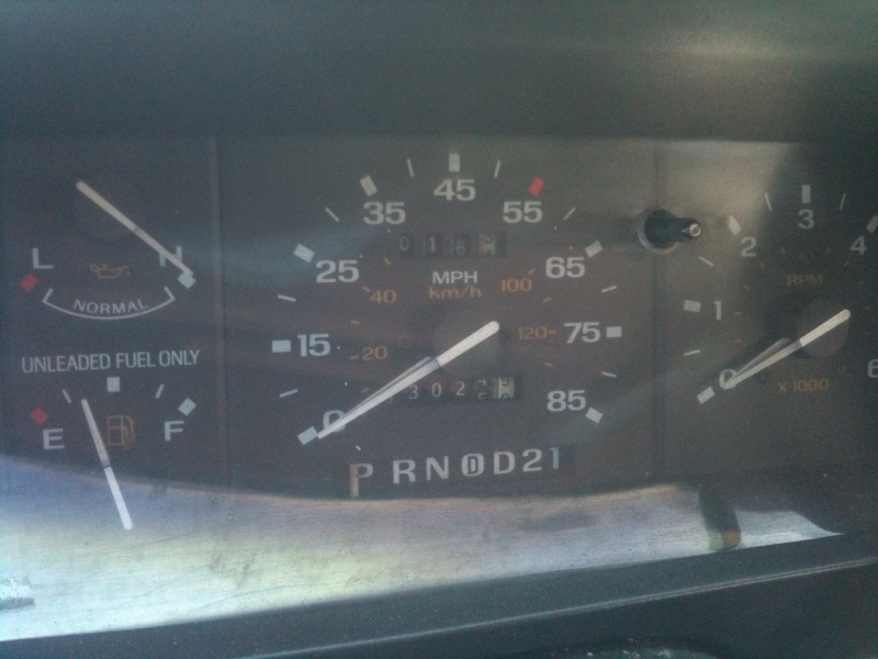 Dashboard with fuel gauge, oil light, speedometer, and odometer showing 30273 miles
