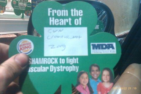 2000 Mercury Grand Marquis - A Burger King shamrock card is held up, the MDA logo and handwritten notes, promoting a fundraiser.
