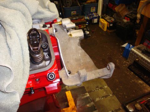 1989 Ford Bronco - Close-up of an engine component and bracket, with a towel draped over part of the engine.