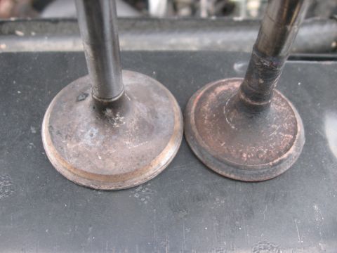1981 Ford Bronco - Comparison of a clean engine valve next to a used one, showing wear and carbon buildup.