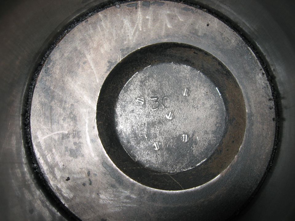 Close-up of an engine cylinder bore with a stamped '30' and other markings
