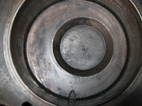 1981 Ford Bronco - Close-up view of an engine cylinder interior, showing stamped markings and screw heads.