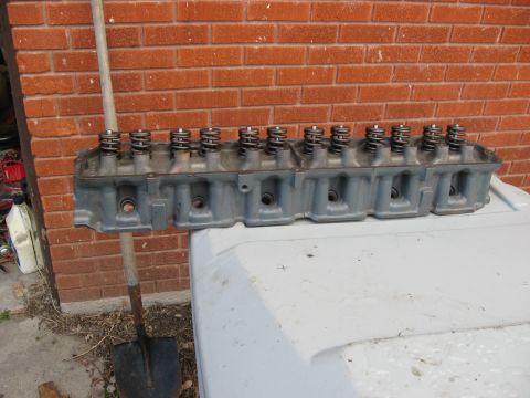 1981 Ford Bronco - Engine cylinder head with valve springs visible, resting on a white surface.