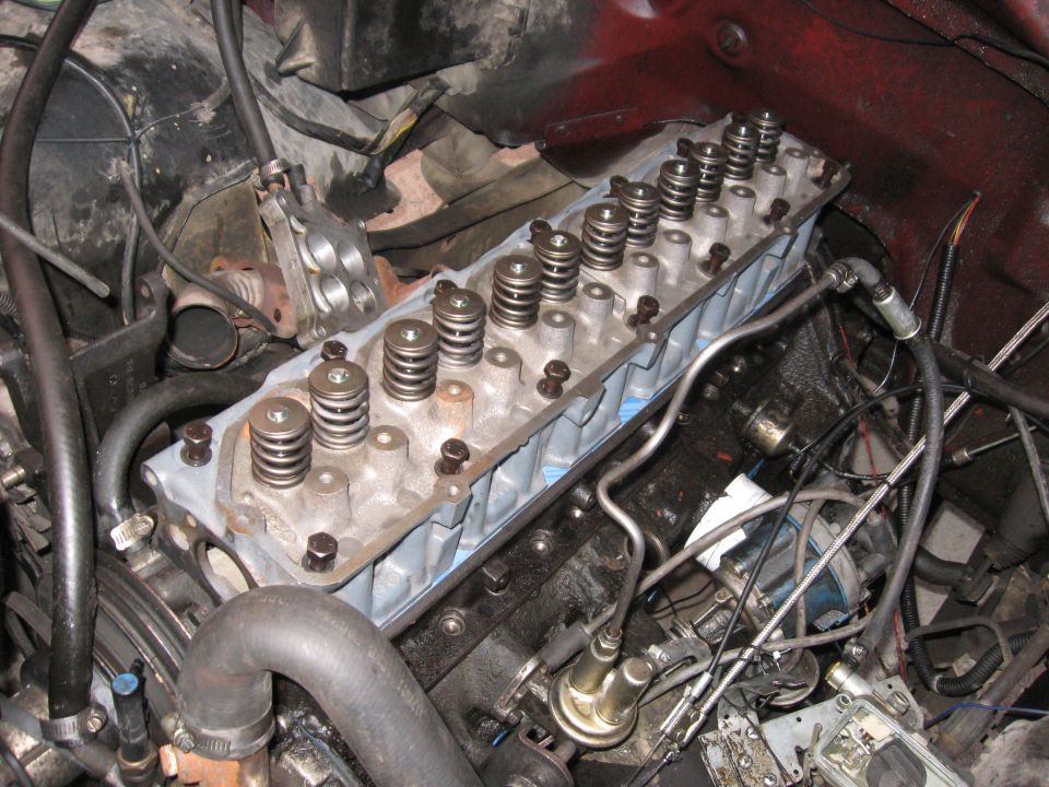 Engine cylinder head with valve springs and bolts, viewed from above