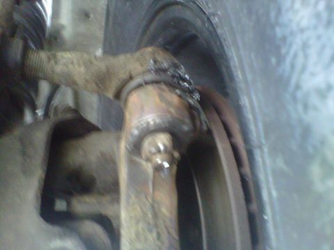 1994 Ford F-150 - Close-up view of a vehicle's suspension tie rod end and brake rotor.
