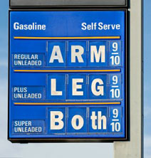 1990 Chevrolet Silverado 1500 - Gas station sign displays prices for Regular, Plus, and Super Unleaded gasoline.