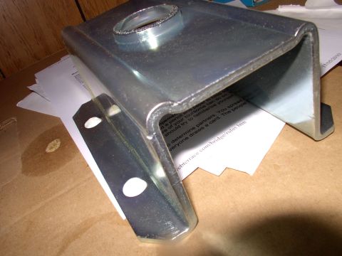1983 Chrysler Fifth Avenue - A metal part for leaf spring repair is shown, with some printed documents underneath.