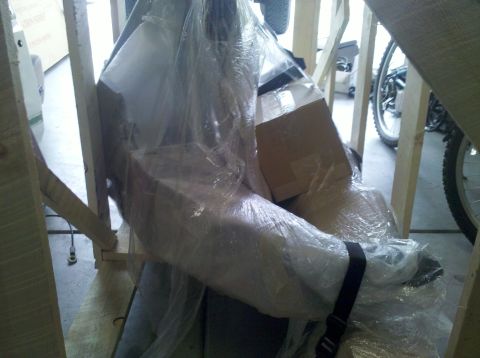 1995 Ford Bronco - Unidentified part wrapped in plastic and secured within a wooden crate.