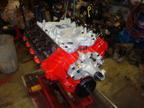 1989 Ford Bronco - Rebuilt V8 engine with red block and silver intake manifold, ready for installation.