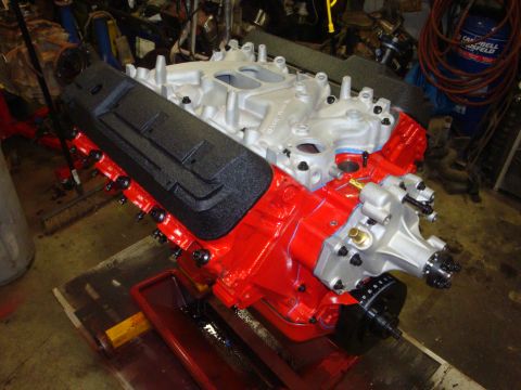 1989 Ford Bronco - A freshly rebuilt engine sits on a stand, ready for installation.