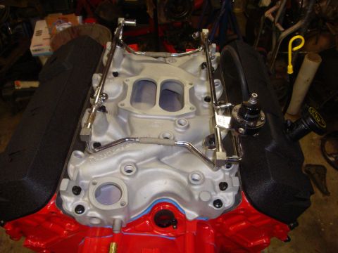 1989 Ford Bronco - Close-up of an engine's intake manifold, fuel rails, and regulator during a rebuild.