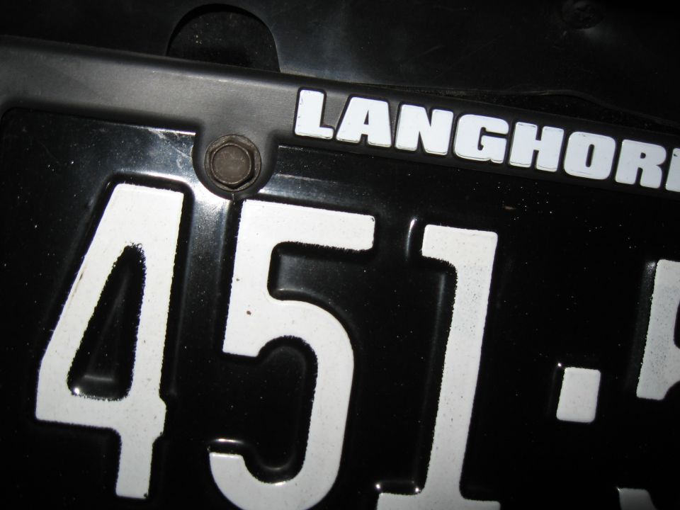 Close-up of a black license plate with white numbers '451' and white text 'LANGHORNE'