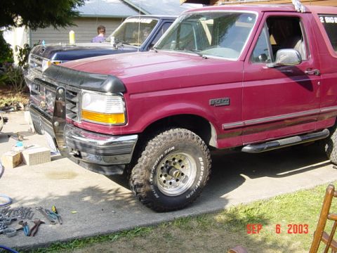 1989 Ford Bronco - Maroon 1989 Ford Bronco with a chrome bumper and aftermarket wheels.