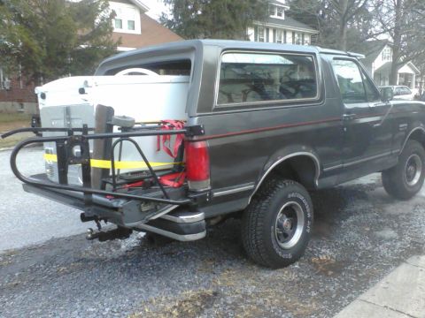1988 Ford Bronco - This 1988 Ford Bronco is equipped with a rear cargo rack carrying a large cooler.