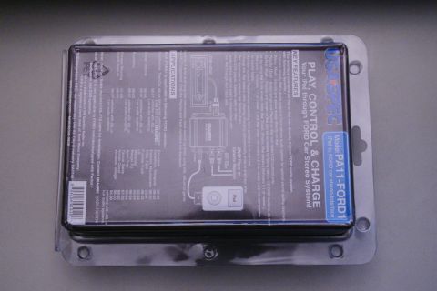 2003 Ford Taurus - The packaging for an iPod car stereo interface, detailing its features and compatibility with Ford systems.