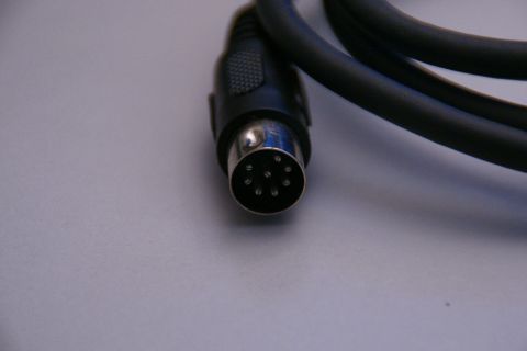 2003 Ford Taurus - Connector cable with a 6-pin DIN plug, likely for audio or data transmission.