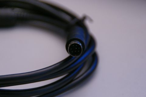 2003 Ford Taurus - Coiled black audio cable with a multi-pin connector visible.