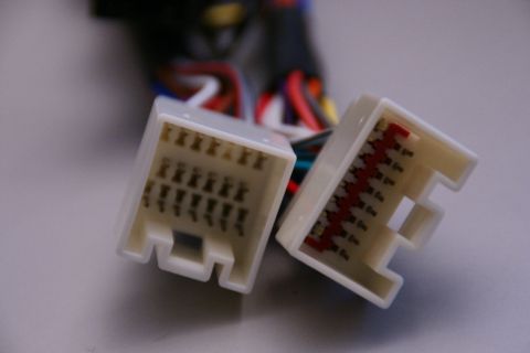 2003 Ford Taurus - Close-up of two automotive wiring harness connectors, each with multiple pins and colorful wires.