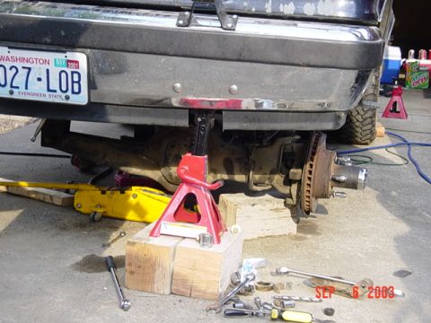 1989 Ford Bronco - Vehicle undergoing rear axle service, supported by jack stands and blocks. Date stamp shows Sep 6, 2003.