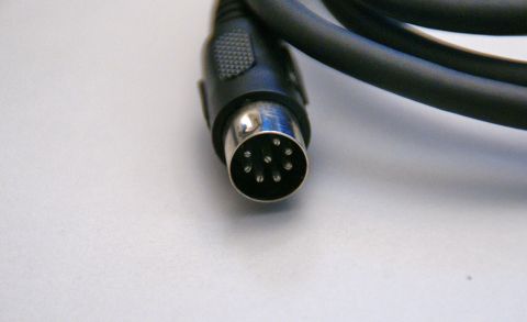 2003 Ford Taurus - This is a close-up of a 6-pin DIN connector on a black cable.