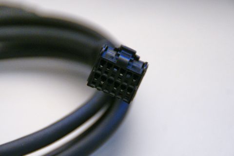 2003 Ford Taurus - A close-up view of a black cable and its multi-pin connector against a white background.
