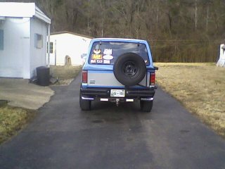 1985 Ford Bronco II - Rear view of a blue 1985 Ford Bronco II parked on a driveway. Spare tire mounted on the rear door.