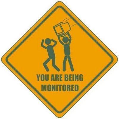 1995 Ford Bronco - This sign depicts two stick figures and warns 'YOU ARE BEING MONITORED'.