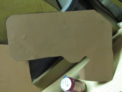 1993 Ford F-250 - A brown cardboard part, possibly a template or insulation, is shown next to a soda can and other materials.