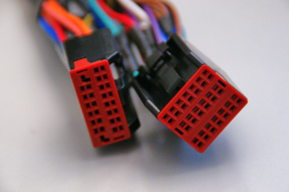 Two red plastic wiring harness connectors with multiple wires
