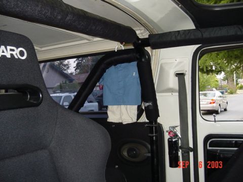 1989 Ford Bronco - The interior of a vehicle shows a roll cage and a racing seat, with a shirt hanging from a hook. A timestamp reads SEP 6 2003.