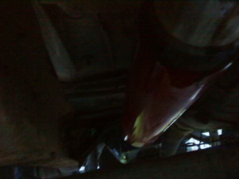 1995 Ford Bronco - The underside of a vehicle is visible, with a focus on a red component.