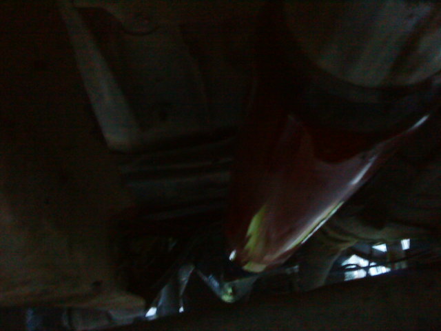 Undercarriage view of a red vehicle part