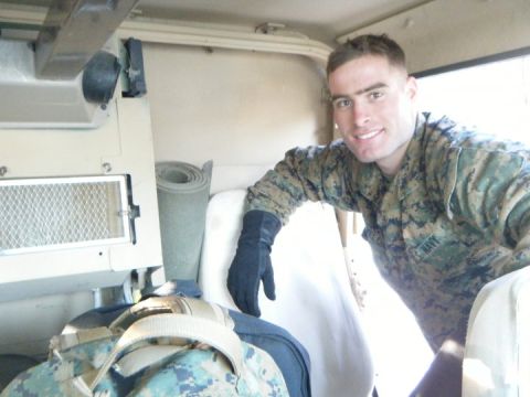 1990 Ford Probe - A smiling Marine in uniform poses for a selfie from the interior of a military vehicle, possibly Humvee-style, vehicle.