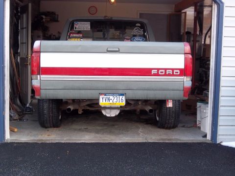 1989 Ford F-150 - The rear of a Ford F-150 pickup truck is visible, parked inside a garage.