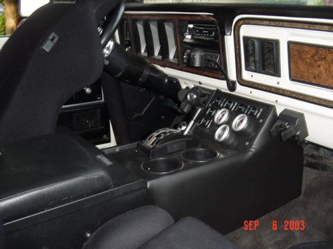 1989 Ford Bronco - Custom center console with gauges and shifter in a vehicle interior.