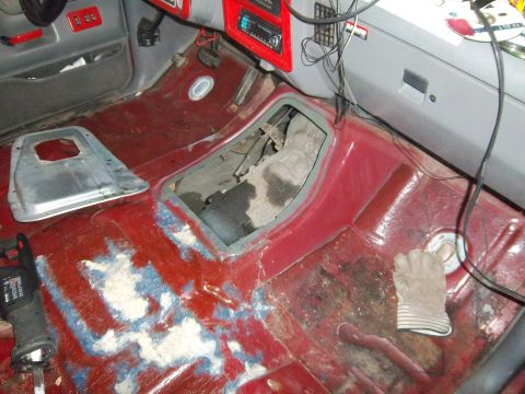 1989 Ford F-150 - The interior of a 1989 Ford F-150 shows the transmission tunnel with the floor removed during an upgrade.