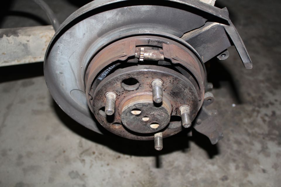 Rear drum brake hub with wheel studs on a vehicle