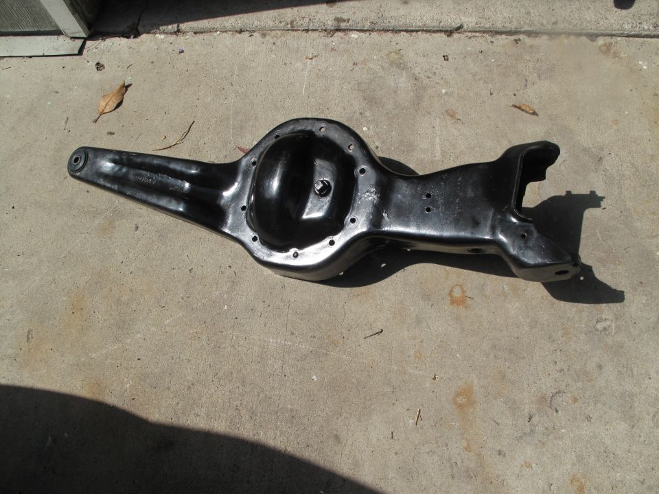 Black painted vehicle axle/differential housing part on concrete