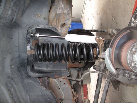 1995 Ford Bronco - Vehicle suspension components, including a coil spring and shock absorber, are visible in this close-up view.