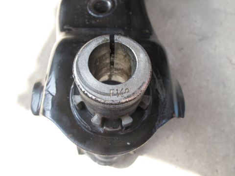 1995 Ford Bronco - A close-up view of a metal component, possibly a suspension part, with the marking 'F 1/2' visible.
