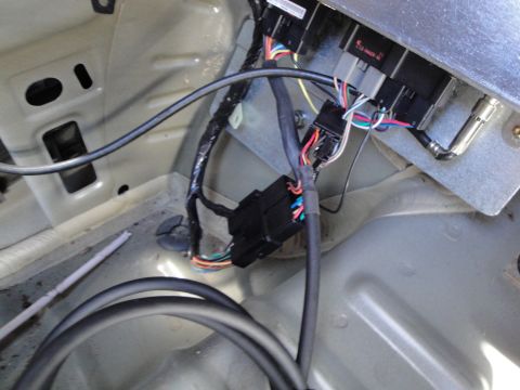 2003 Ford Taurus - Close-up view of a vehicle's wiring harness and connectors, showing various colored wires.