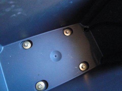 2003 Ford Taurus - Close-up view of a dark blue plastic interior component with visible mounting hardware.