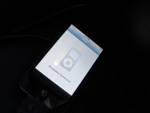 2003 Ford Taurus - iPod connected to a car accessory, displaying connection status on screen.