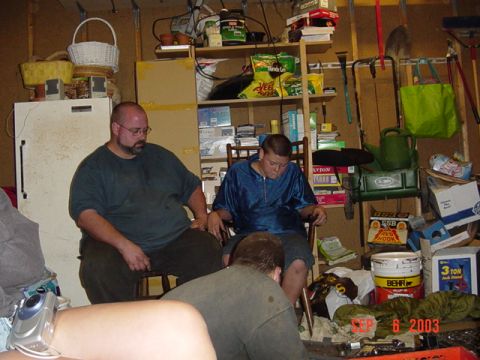 1989 Ford Bronco - People gathered in a messy garage on September 6, 2003.