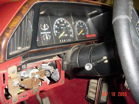 1989 Ford Bronco - The dashboard of a 1989 Ford Bronco shows the speedometer, fuel gauge, and the ignition assembly with wiring exposed.
