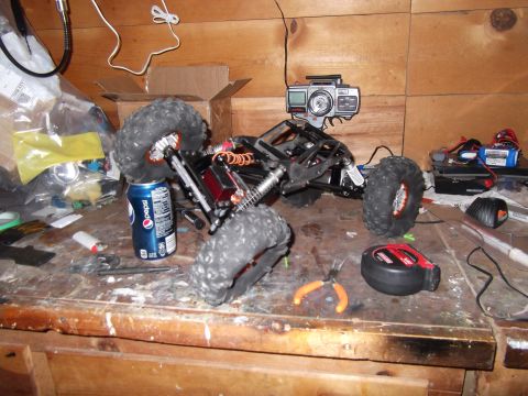 1989 Ford Bronco - A remote control rock crawler sits on a workbench, supported by a can of Pepsi, with a camera attached to its roof.