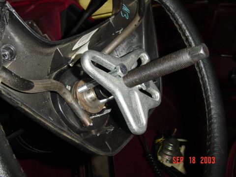 1989 Ford Bronco - A steering wheel puller tool is attached to the steering column, indicating a repair or maintenance procedure.